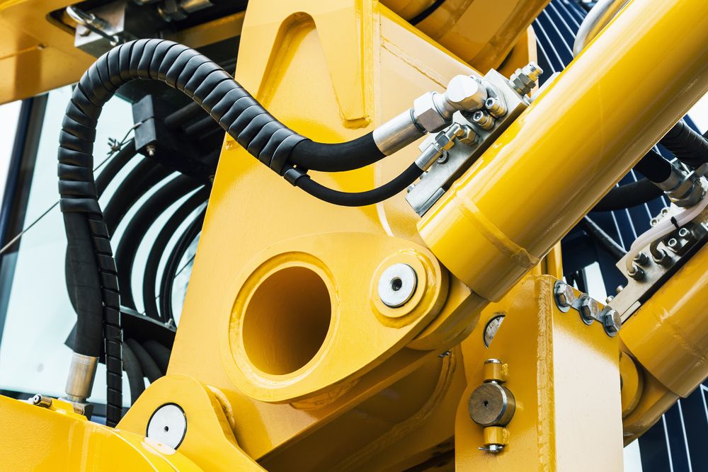 Yellow Hydraulic Machinery, Close-Up. a Metal Arm with A Cylindrical Bore — Berkeley Vale Hydraulics in Fountaindale, NSW