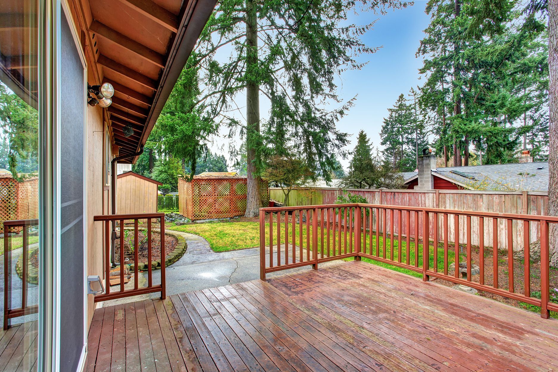 house walkout deck overlooking backyard area
