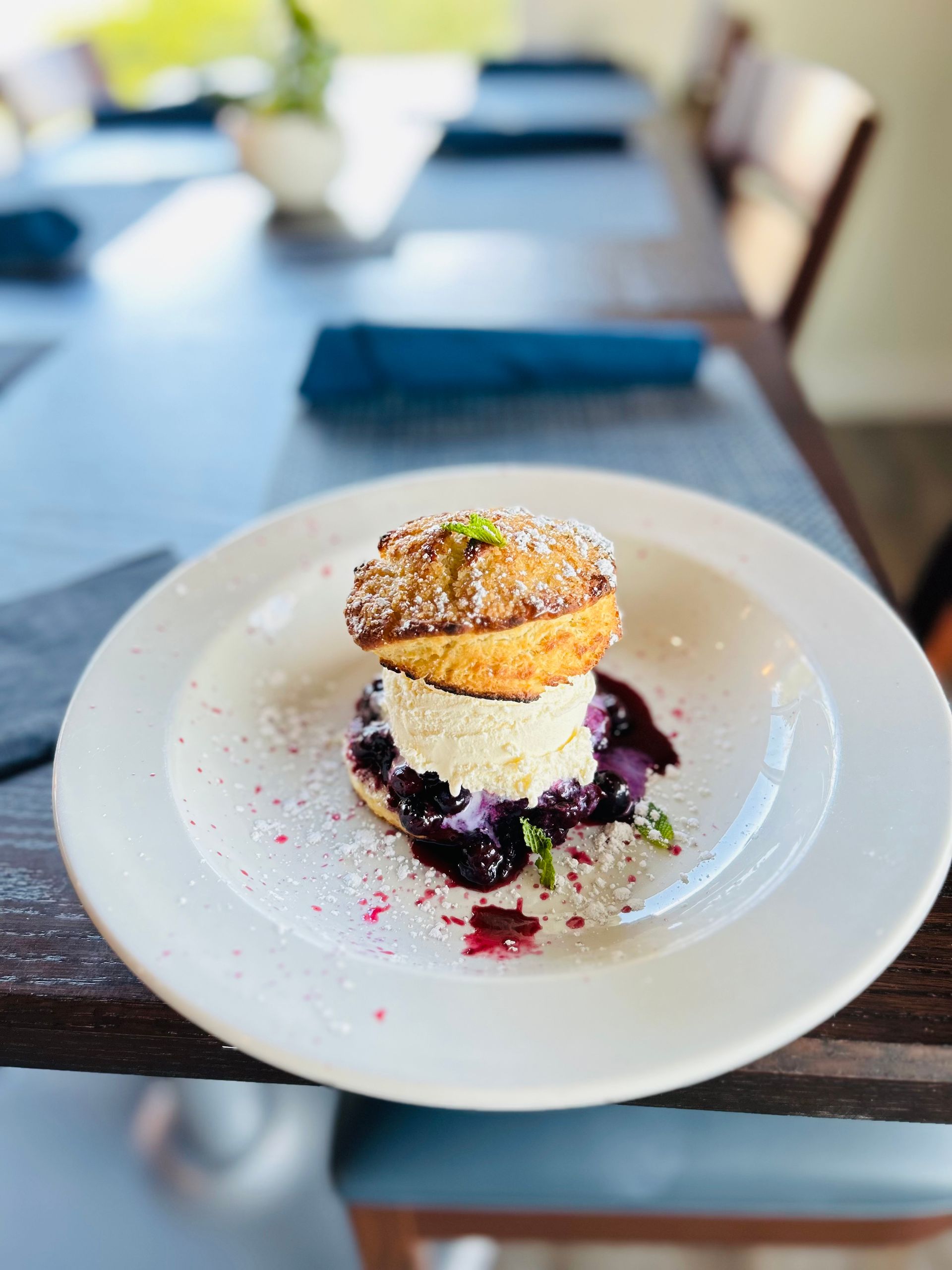A white plate topped with a dessert on a table.
