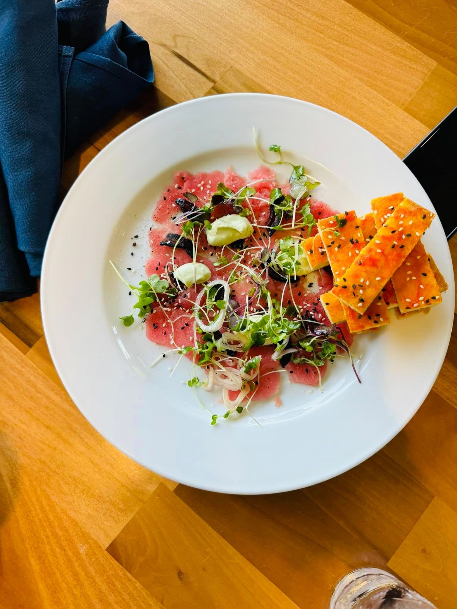 A plate of food is sitting on a wooden table.