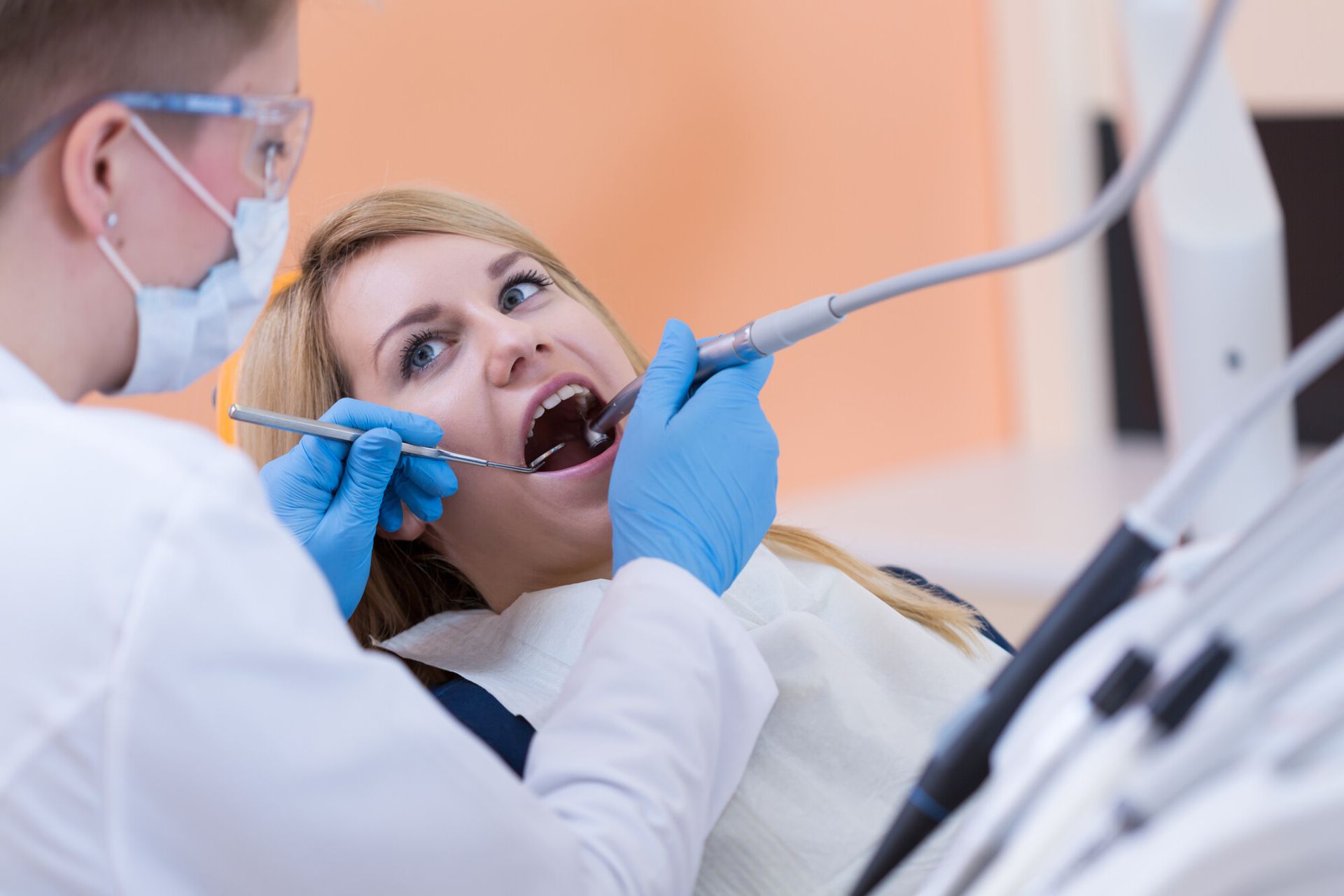 Dentist-drilling-a-tooth-of-young-women