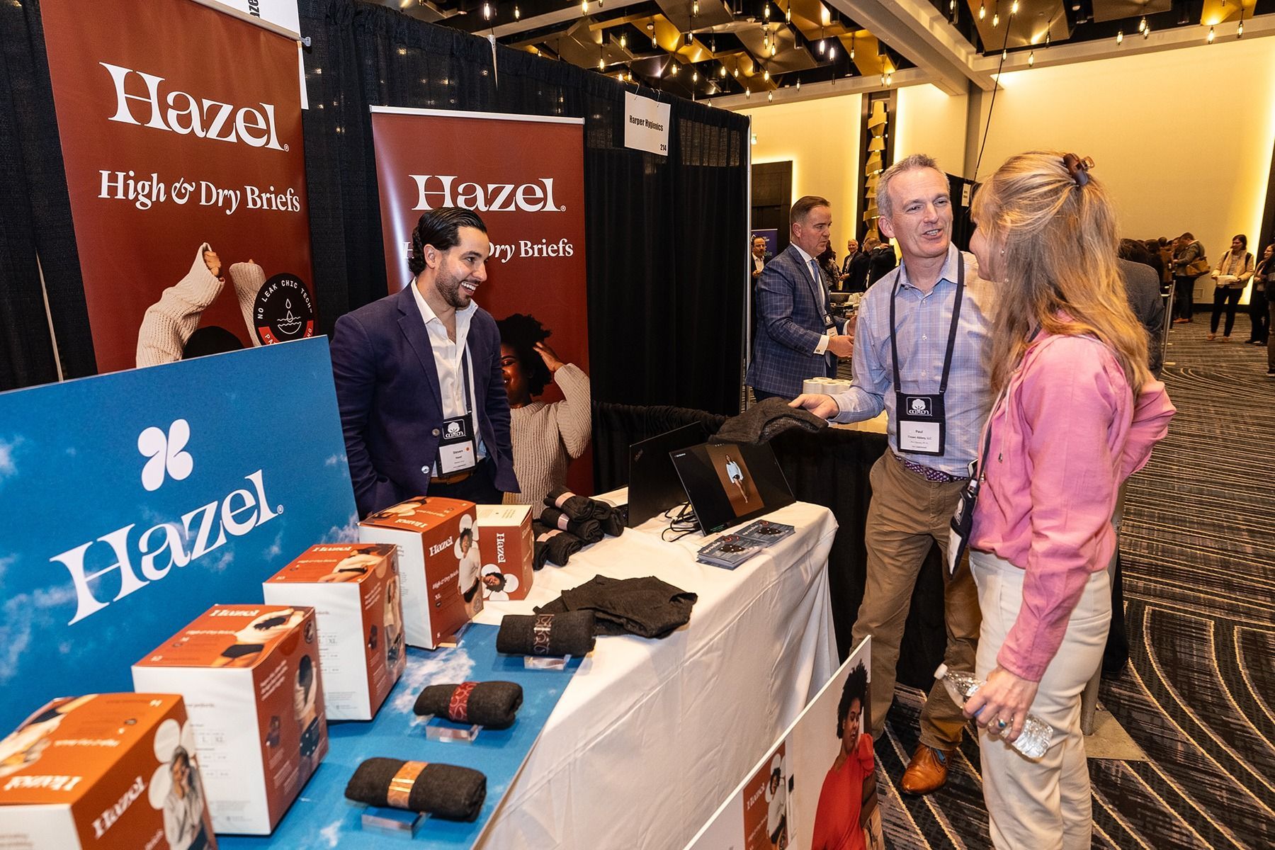 People at a trade show booth with 