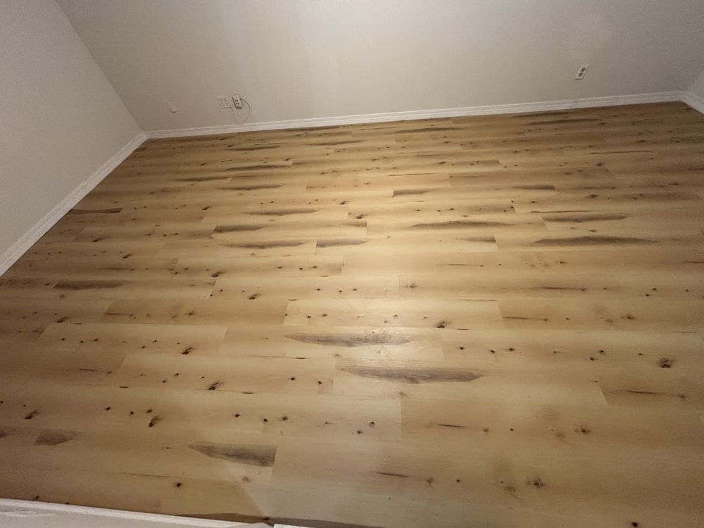 Empty room with light wood floors and white walls