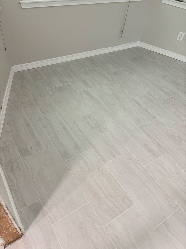 Empty room with light gray wood-look flooring and beige walls