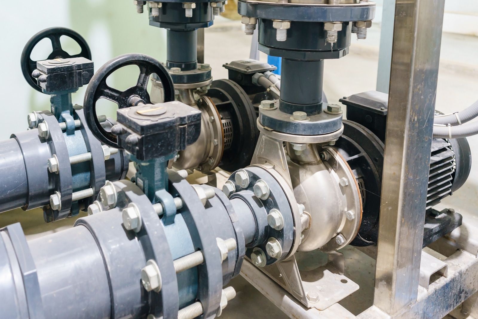 A close up of a pump and valves in a factory.