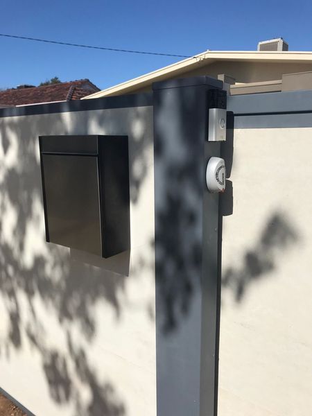 A mailbox is attached to the side of a building.