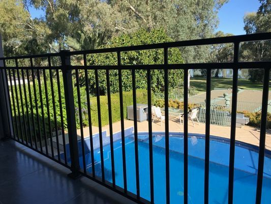 A view of a swimming pool from a balcony.