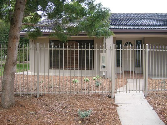 A house with a metal fence surrounding it