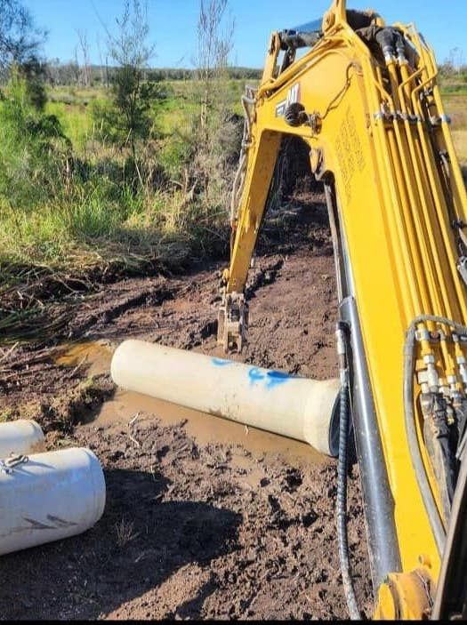 Worker Installing New Drainage Pipe System — CHT Excavation and Hire In Wherrol Flat NSW