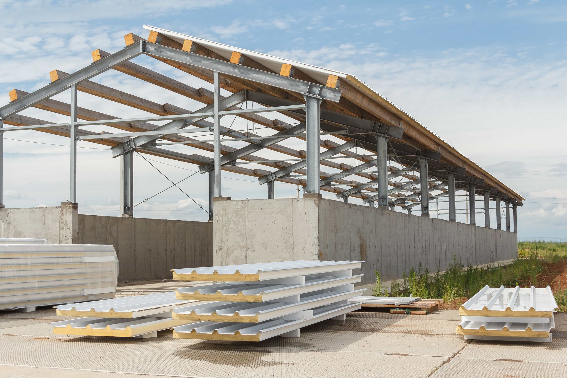 A building under construction with a lot of pieces of metal and wood.