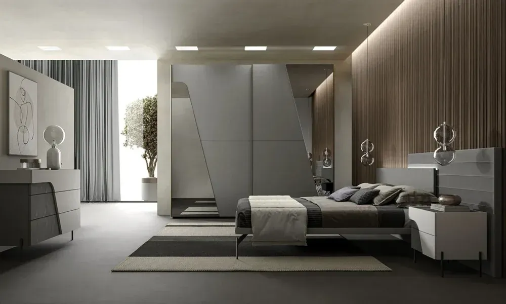 Una camera da letto con letto, cassettiera, comodino e armadio scorrevole.