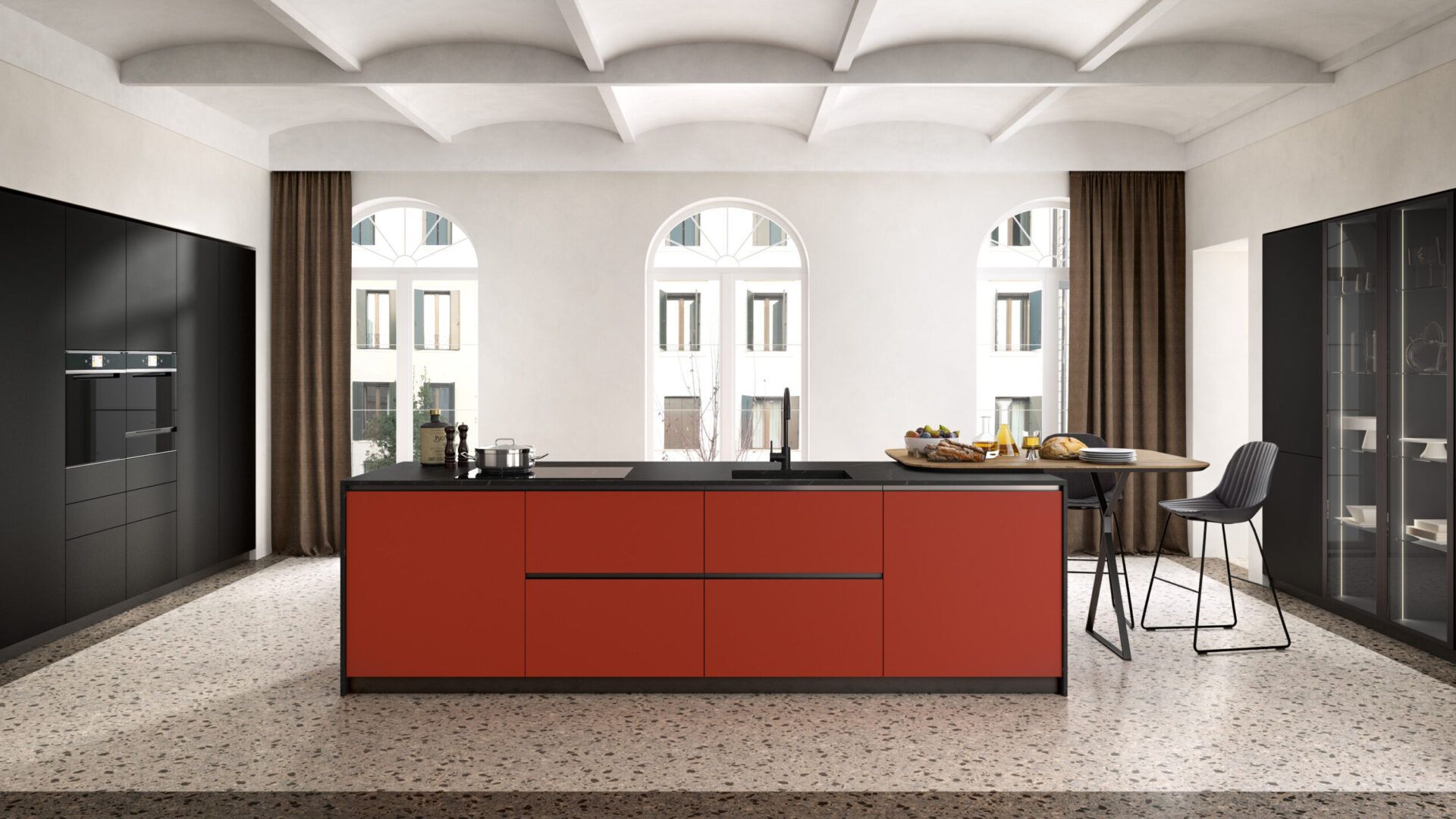 Una cucina con mobili rossi e un piano di lavoro nero