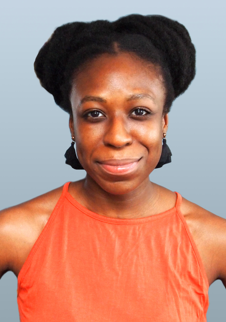 A woman in an orange tank top is smiling for the camera