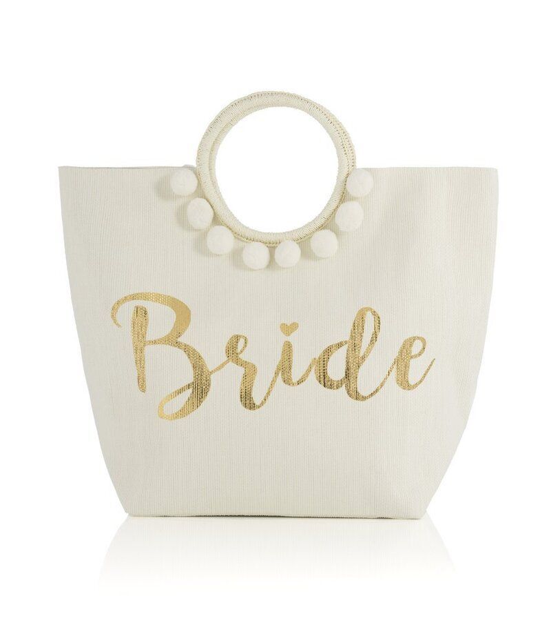 A white tote bag with the word bride on it