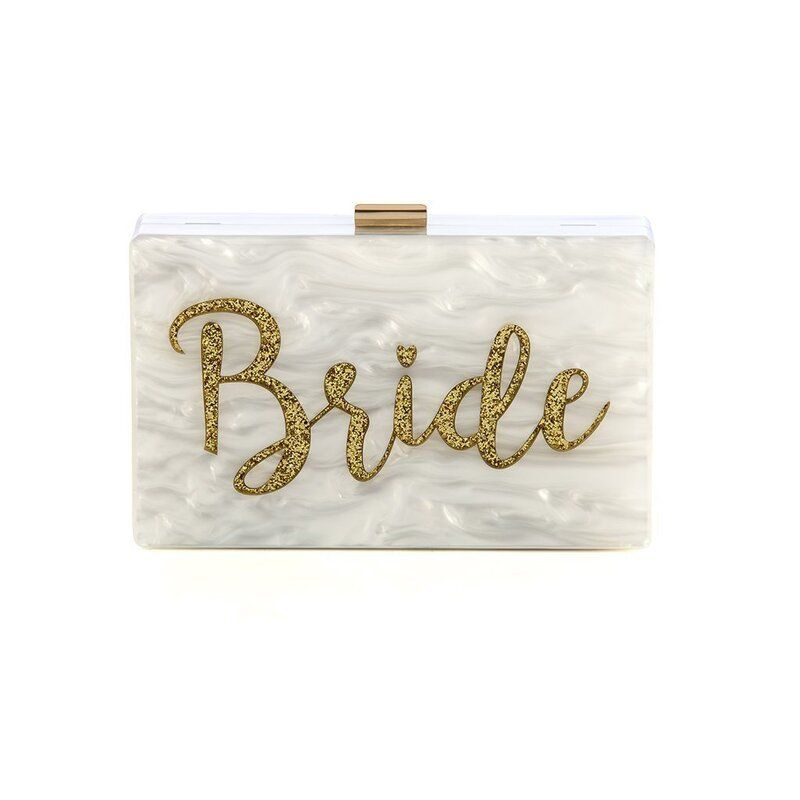 A white clutch bag with the word bride written on it.
