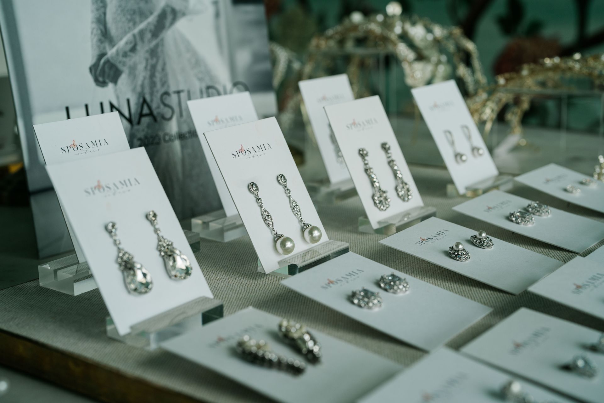 A display of earrings and rings on a table.