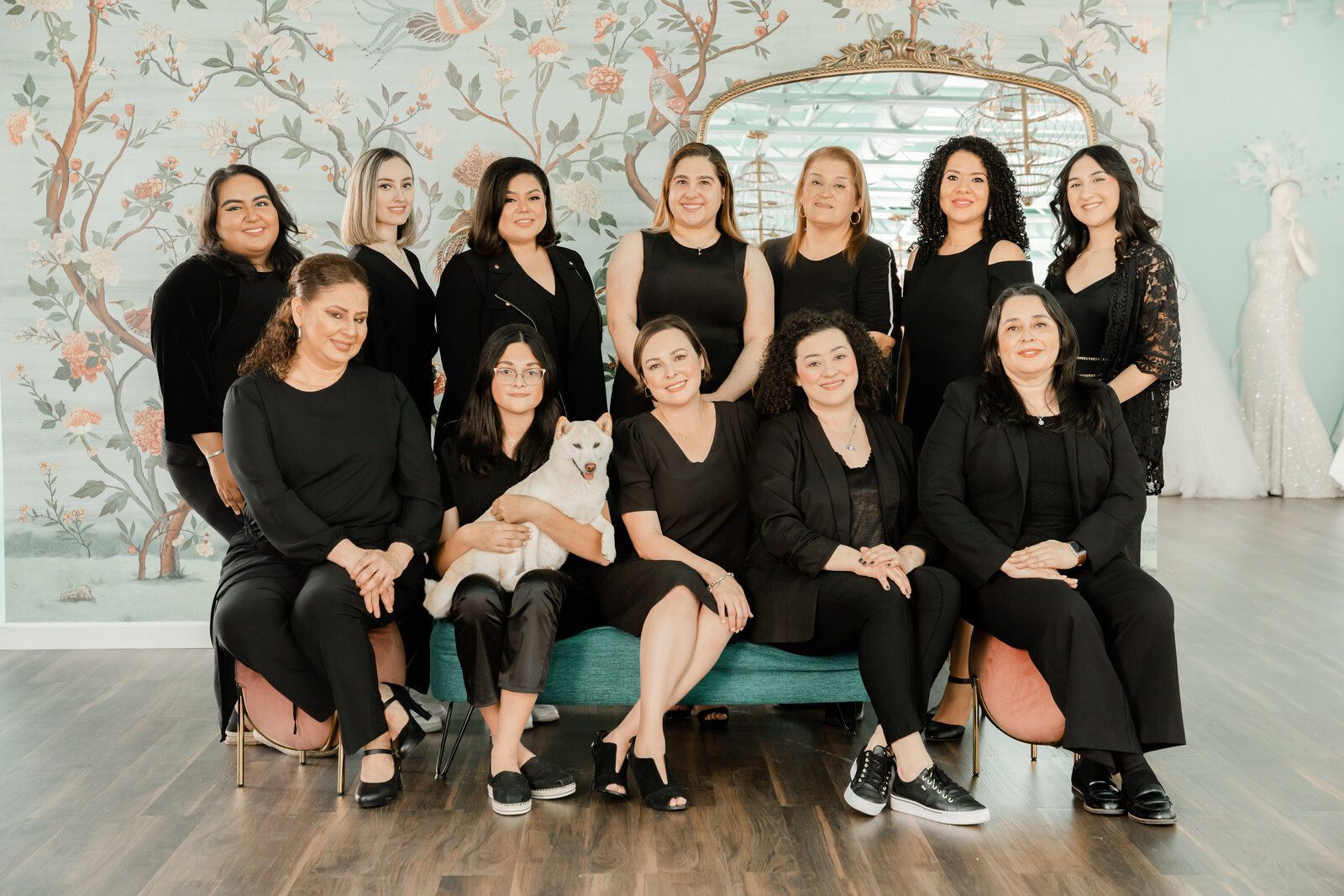 A group of women are posing for a picture while sitting on a couch.