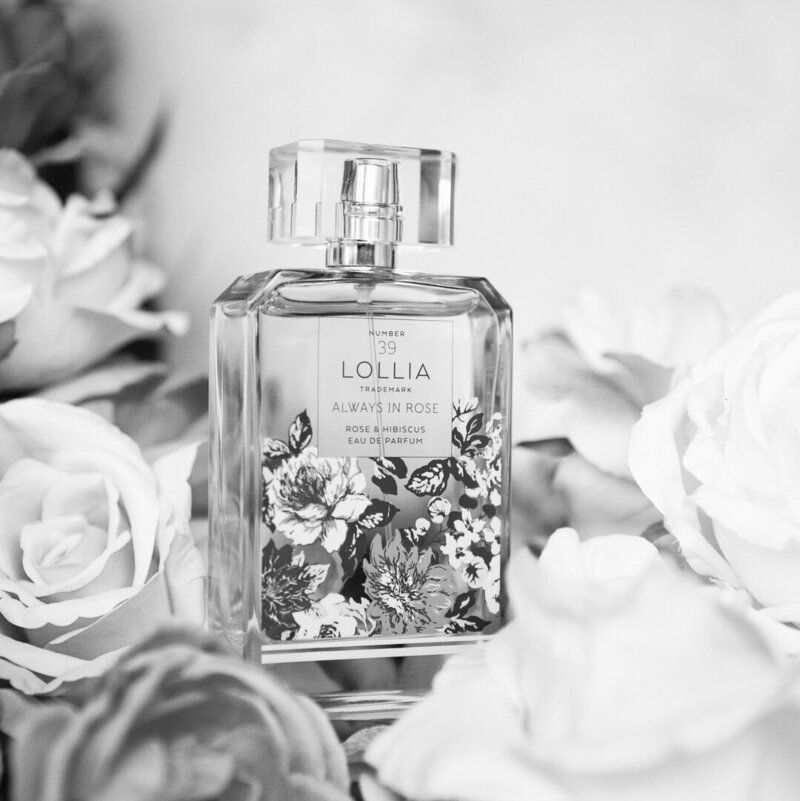 A black and white photo of a bottle of lollia perfume