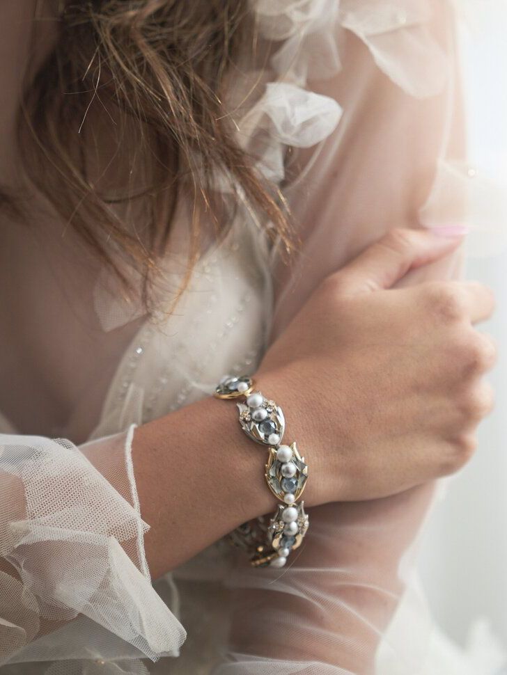 A woman is wearing a bracelet on her wrist.