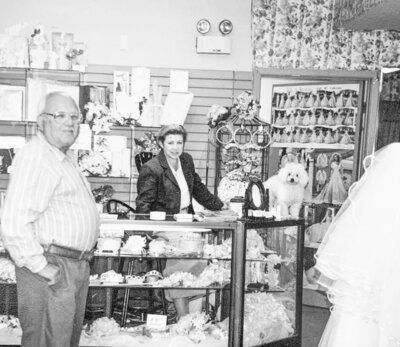 A black and white photo of a man and woman in a store