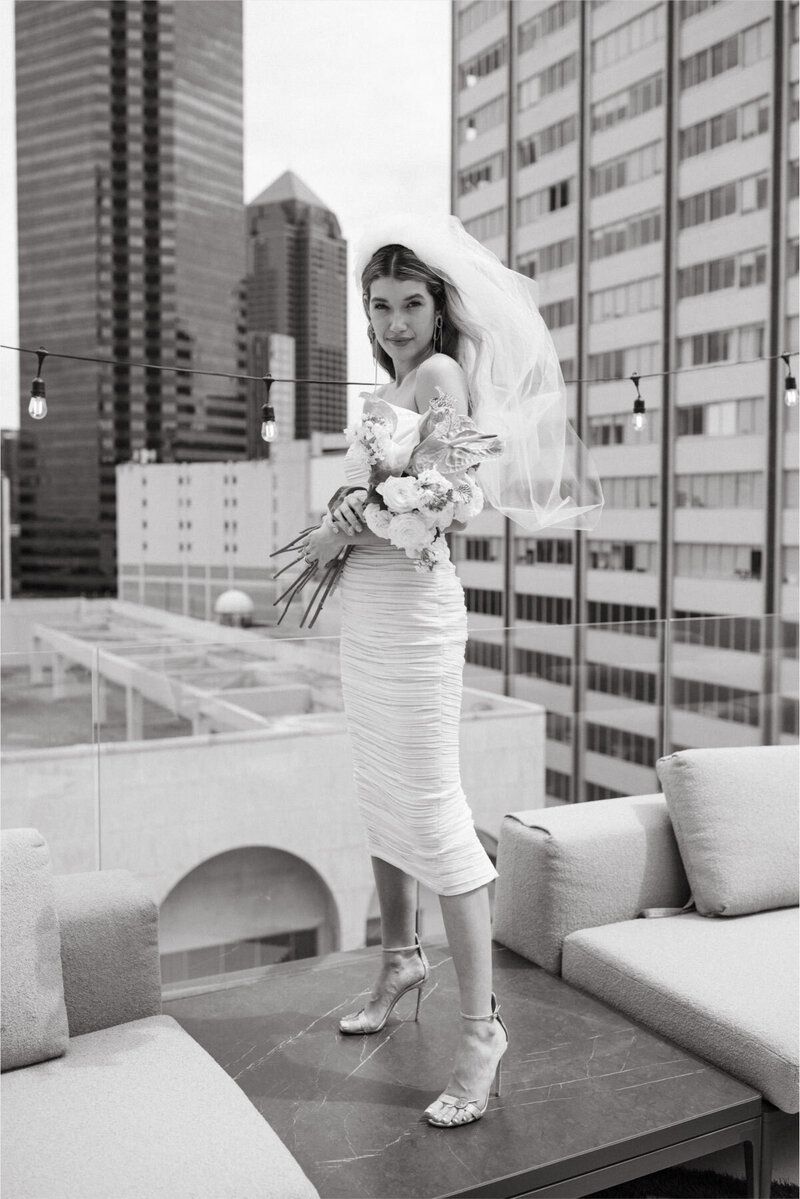 A black and white photo of a woman in a wedding dress and veil.
