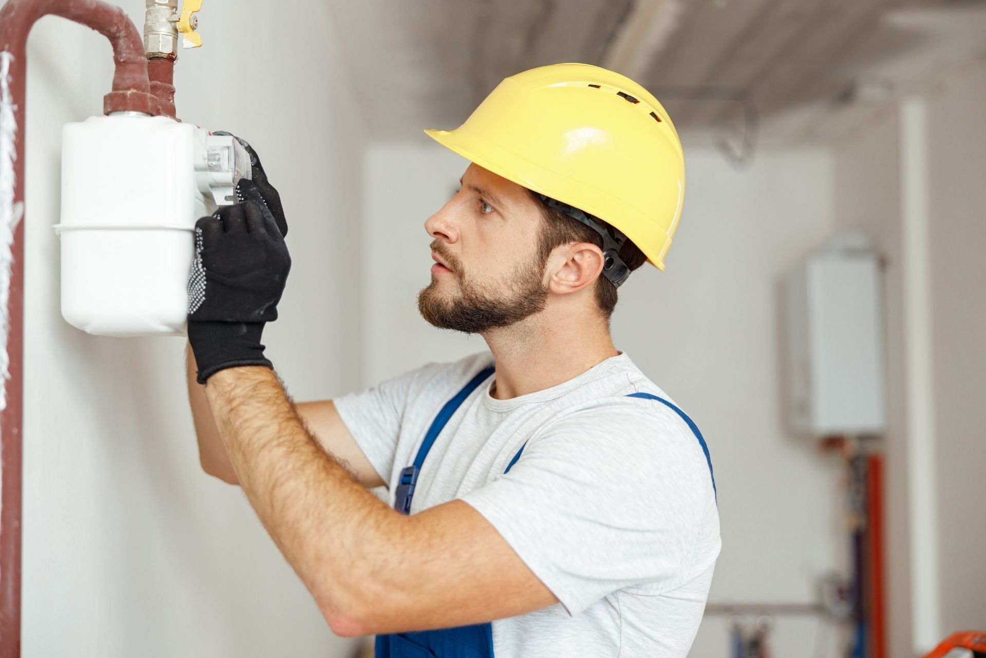 HVAC technician wearing mask and hard hat, working on AC units on a rooftop. HVAC technician wearing mask and hard hat, working on AC units on a rooftop.