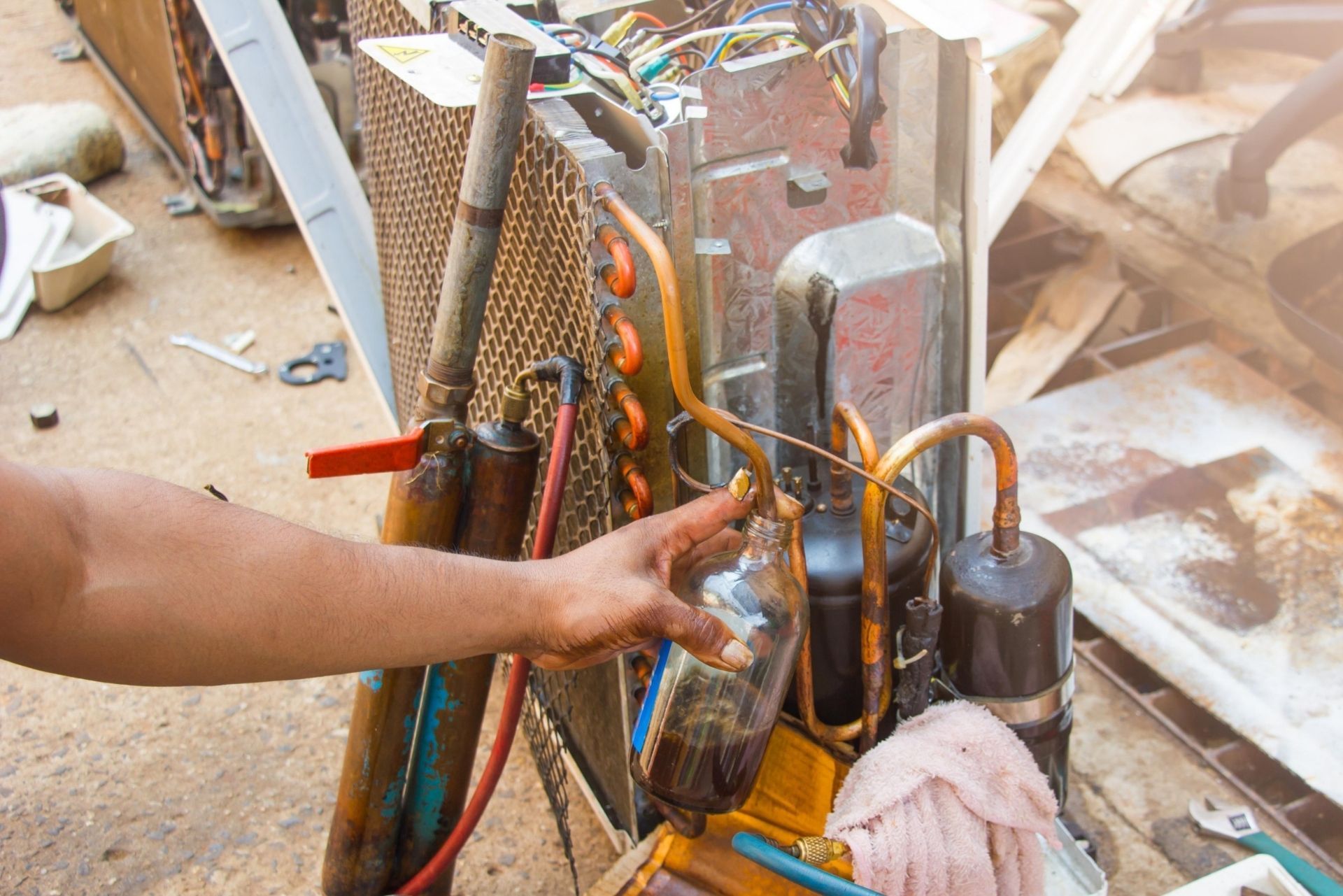 HVAC technician wearing mask and hard hat, working on AC units on a rooftop. HVAC technician wearing mask and hard hat, working on AC units on a rooftop.
