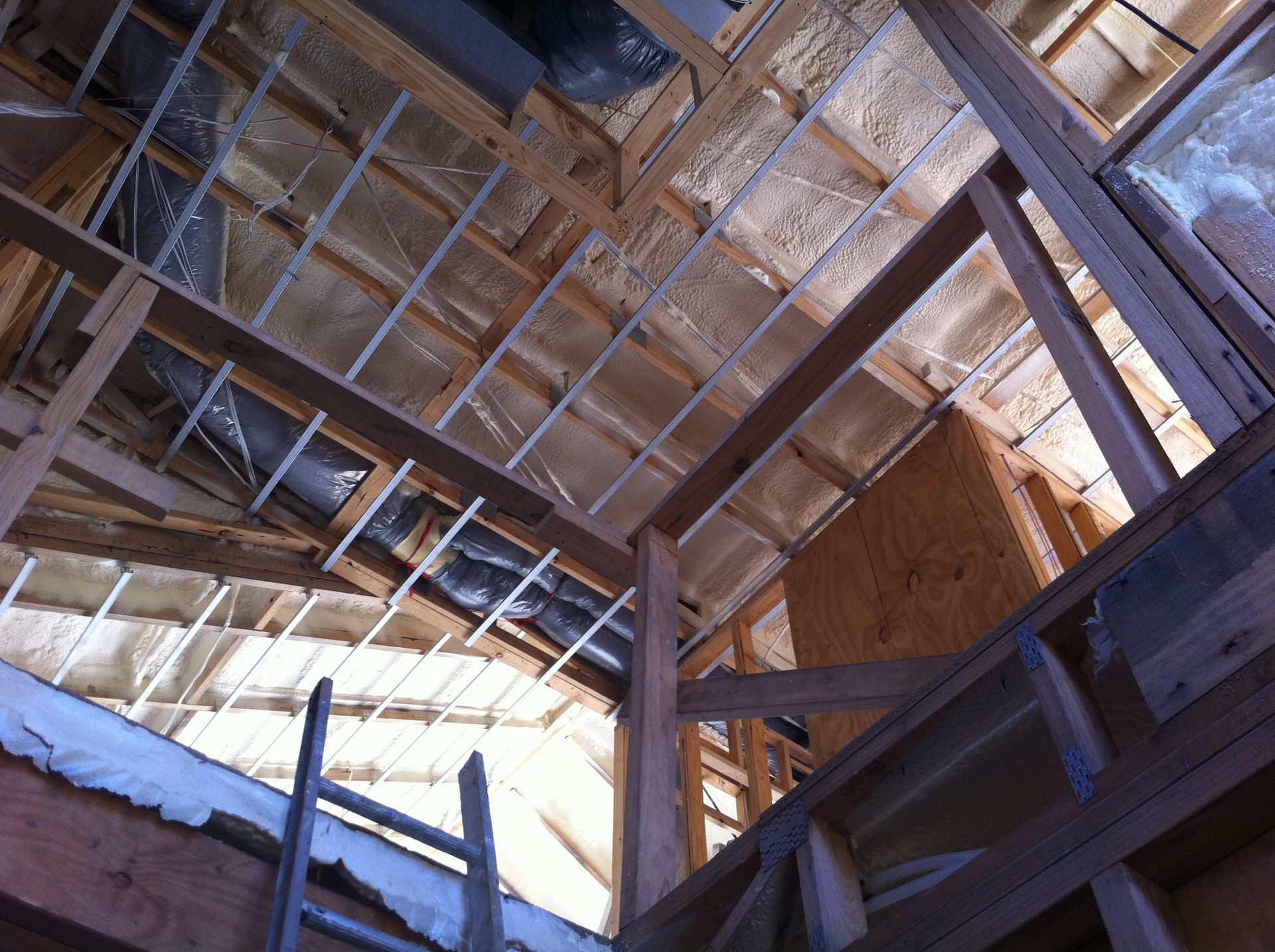 Insulation Foam Coating Under the Roof with a Light Bulb | Pakenham, Vic | Advanced Foam & Coatings Pty Ltd