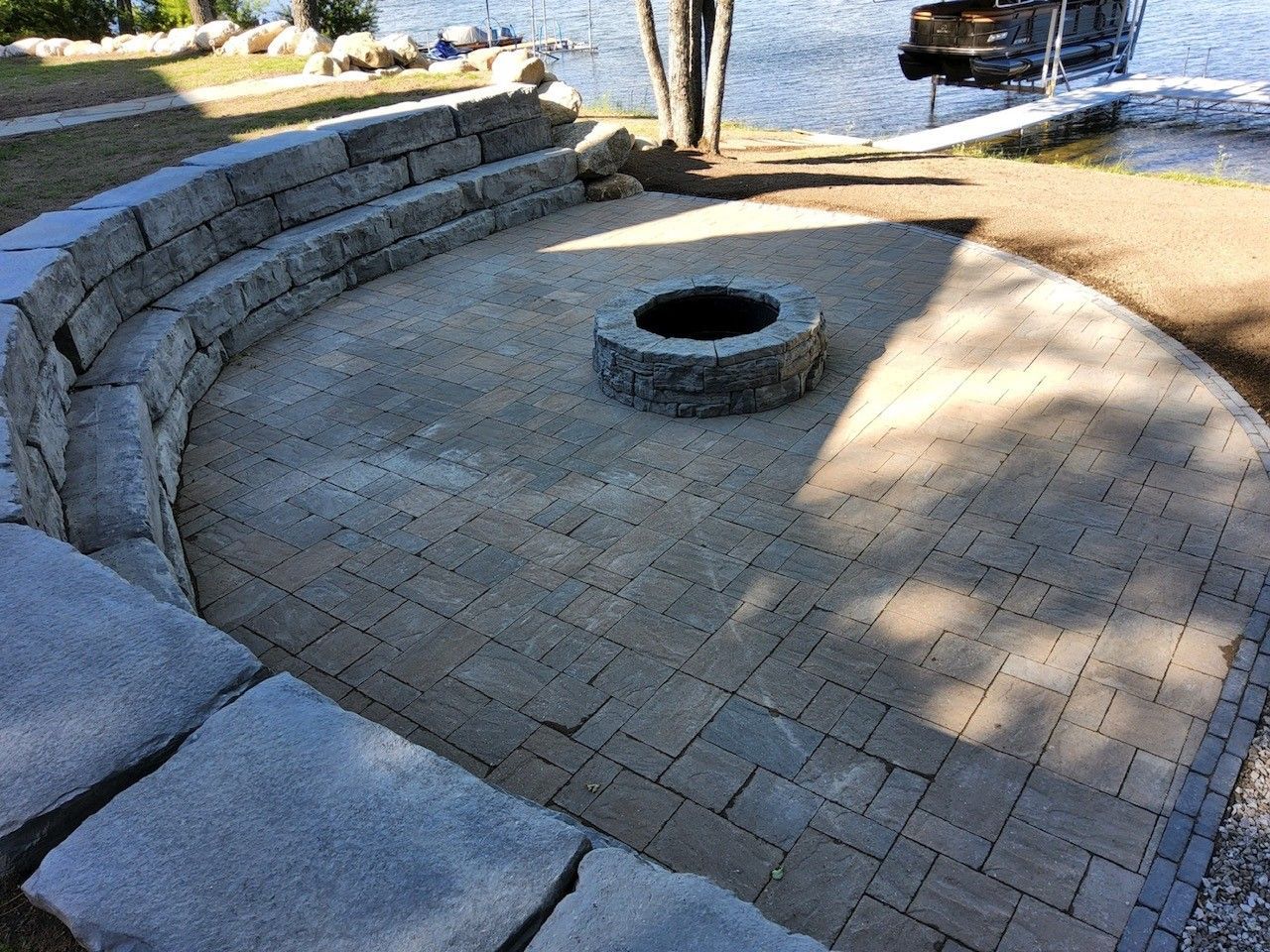 A dirt field with a concrete curb in the middle of it.