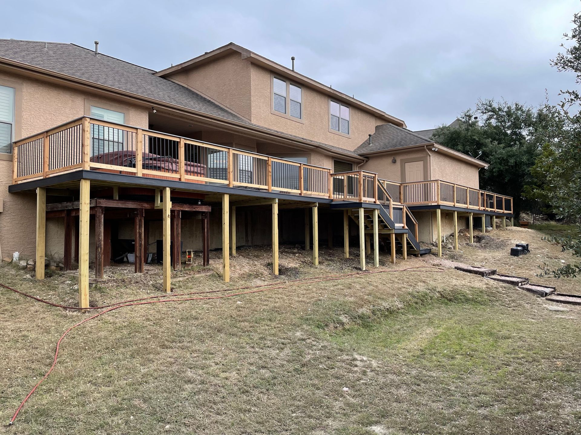 raised deck with hot tub and stairs