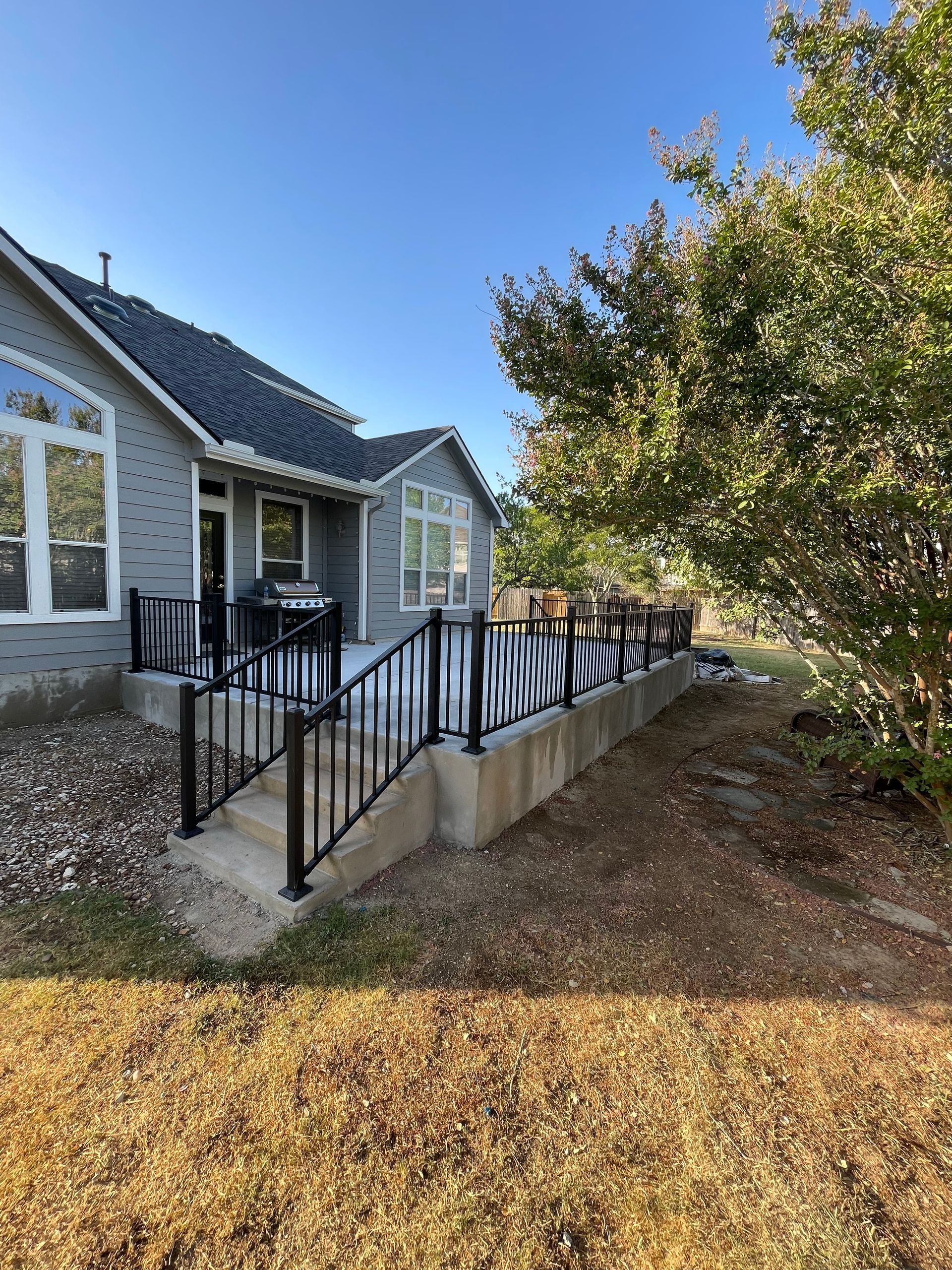 A house with a deck and stairs in front of it.