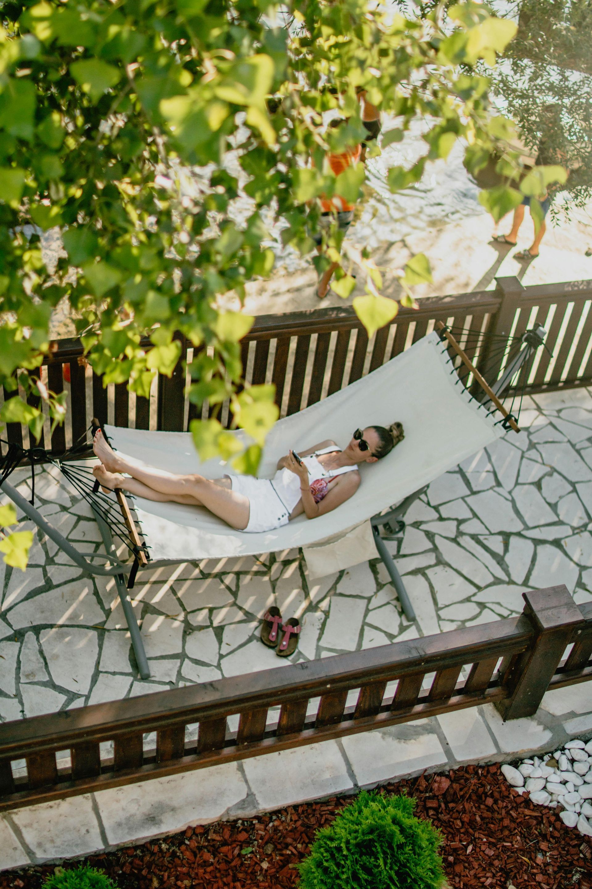 lady on hammock on stone patio walkway
