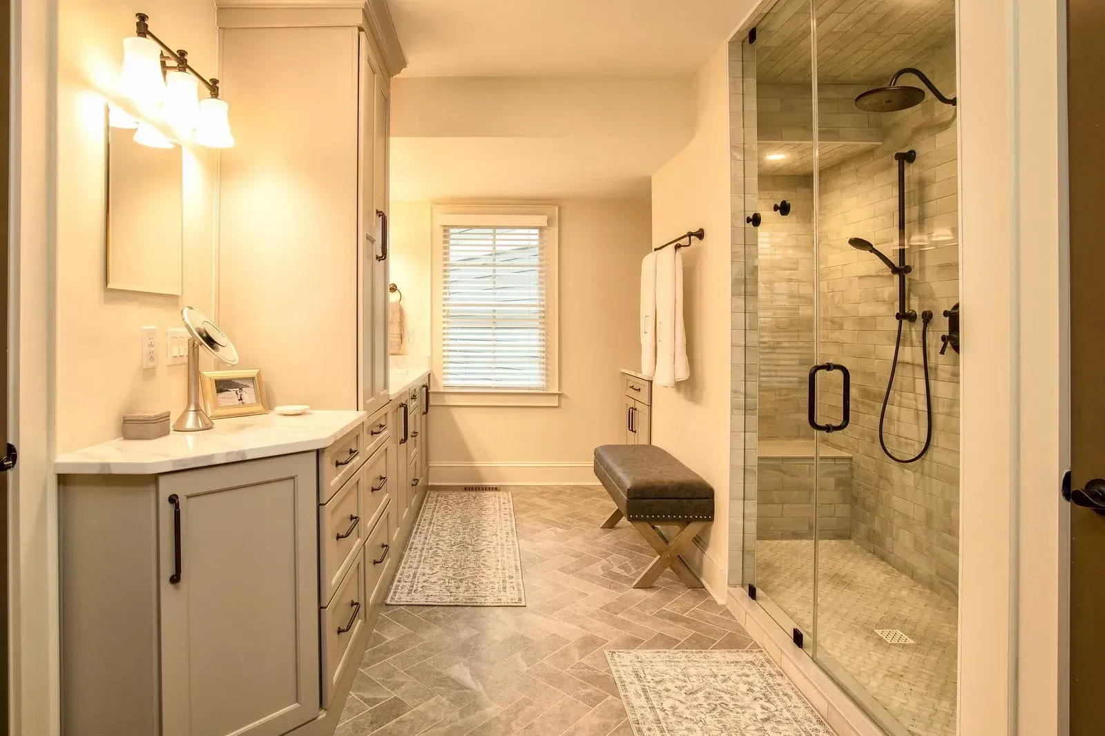 Bathroom remodel in Greenville, South Carolina: white vanity herringbone niche shower