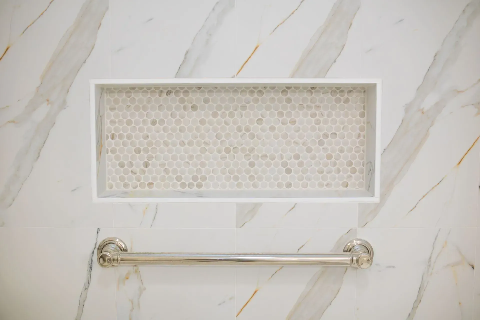Bathroom remodel in Greenville, South Carolina: marble look shower niche grab bar