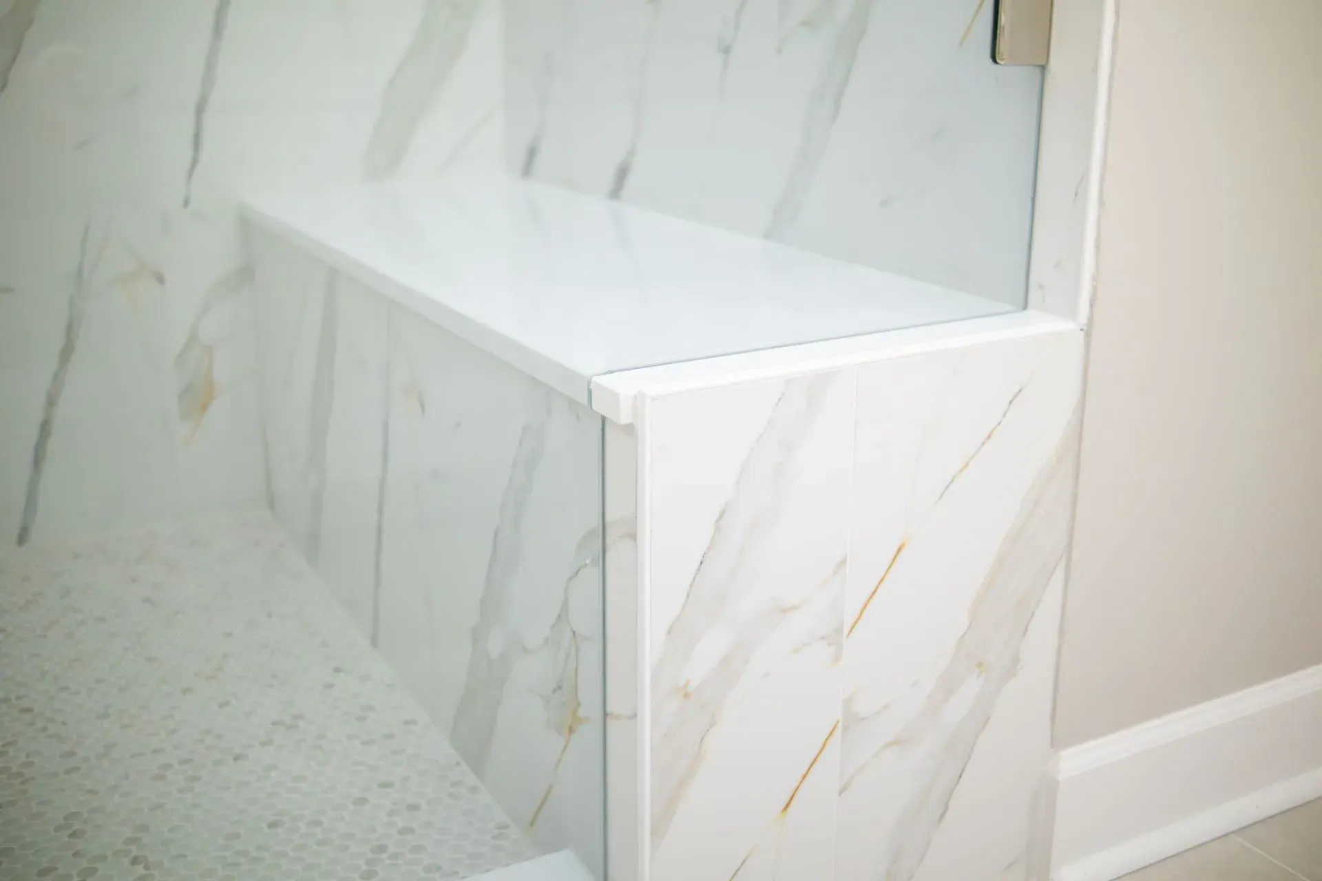 Bathroom remodel in Greenville, South Carolina: marble look shower bench