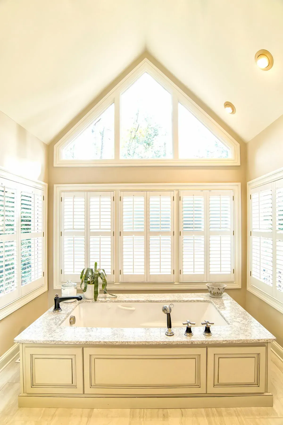 Bathroom remodel in Greenville, South Carolina: soaking tub arched window
