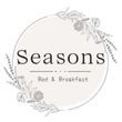 A logo for a bed and breakfast with flowers in a circle.