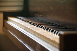 A close up of a piano keyboard with the keys visible A close up of a piano keyboard with the keys visible
