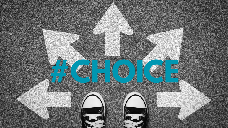 A pair of feet in sneakers at a sign Choices with arrows pointing in different directions. 