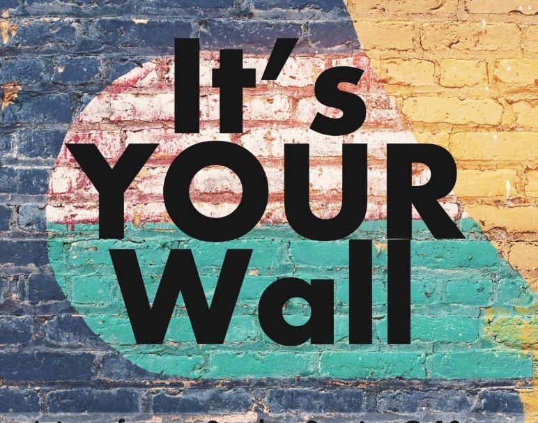 A brick wall with the words it 's your wall painted on it