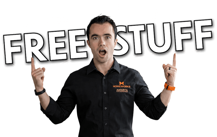 Man holding a “FREE STUFF” sign, with white arrows pointing to the words on a dark background.