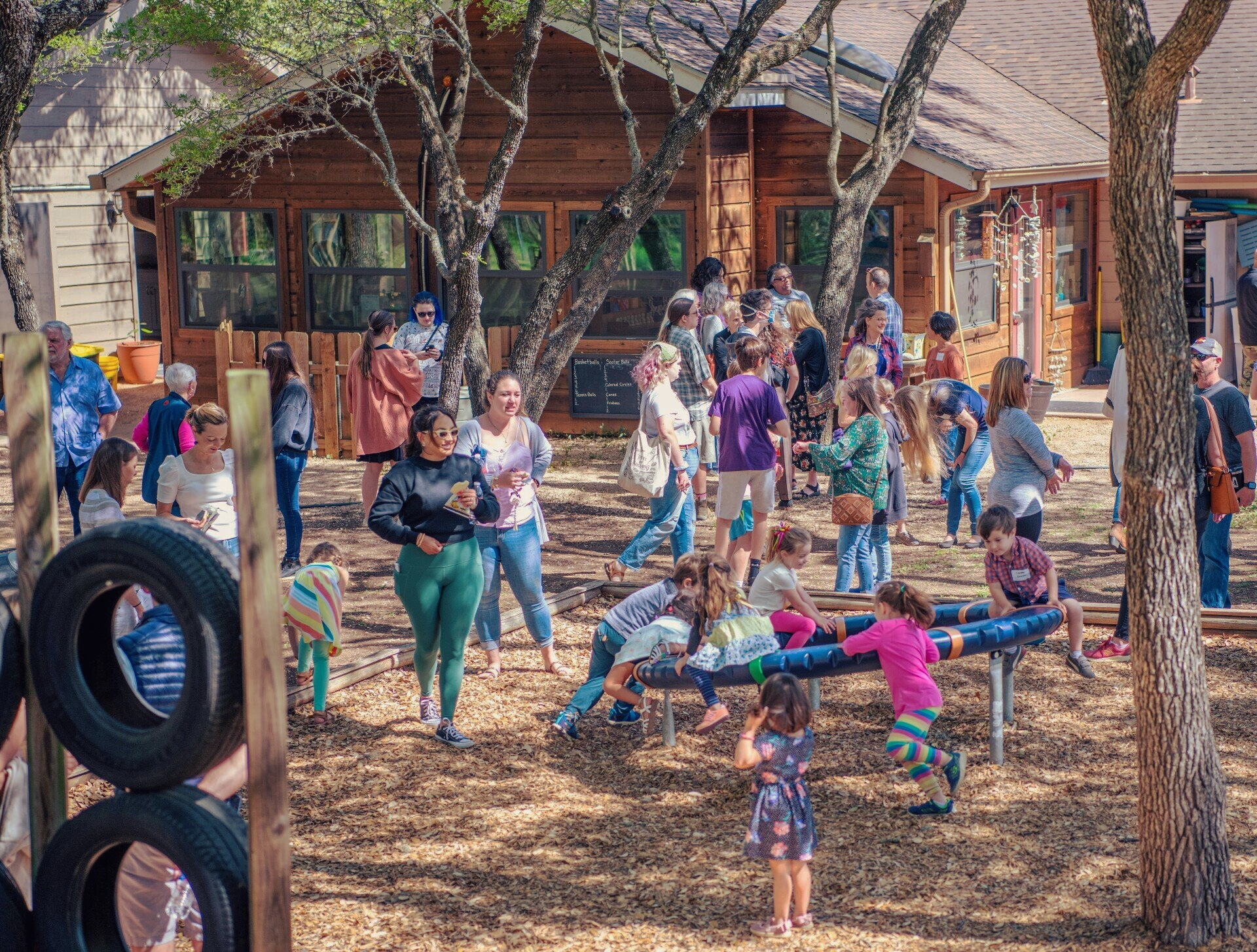 A group of people are playing in a Parkside school playground.