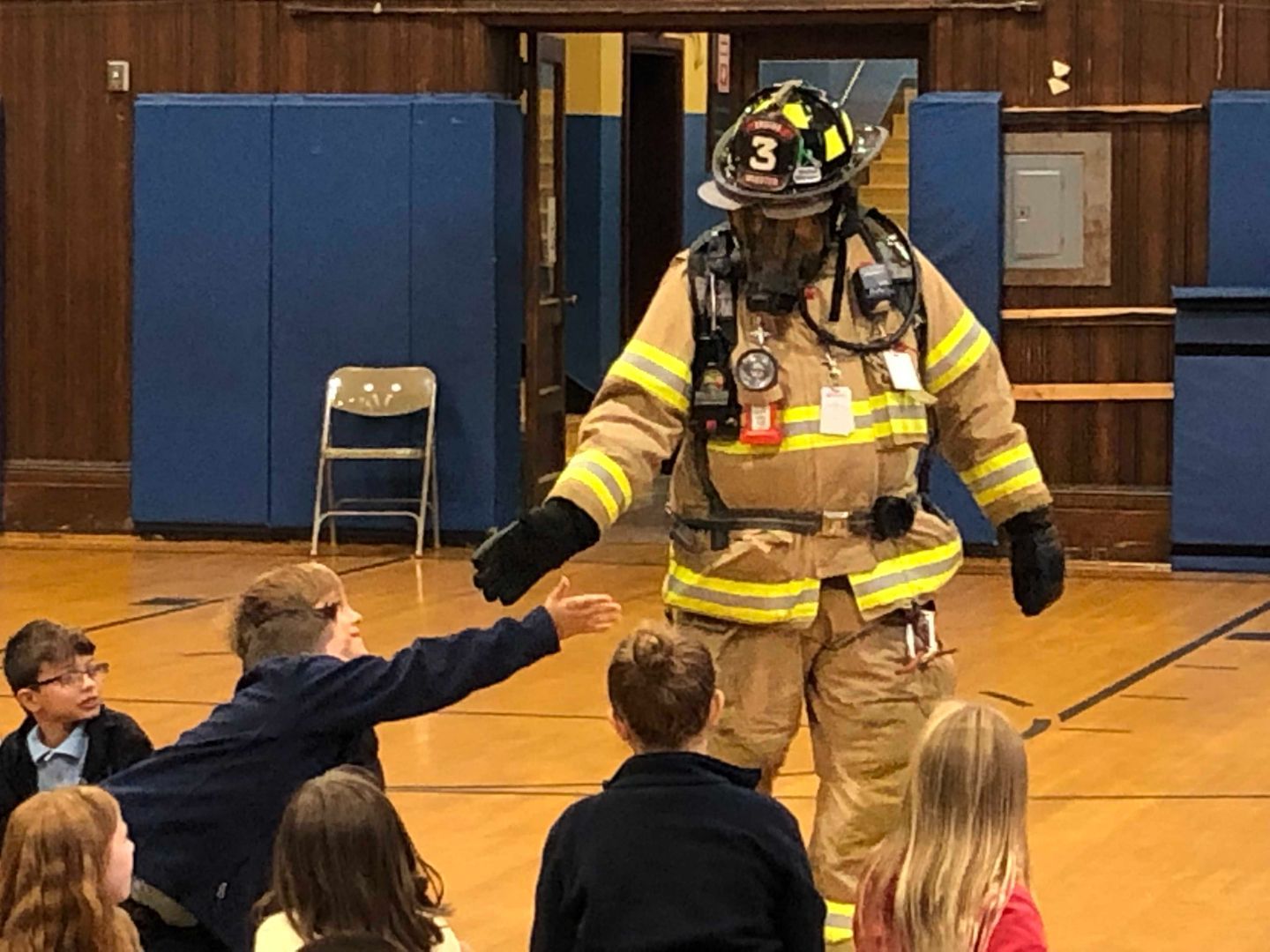 A fireman wearing a helmet with the number 3 on it