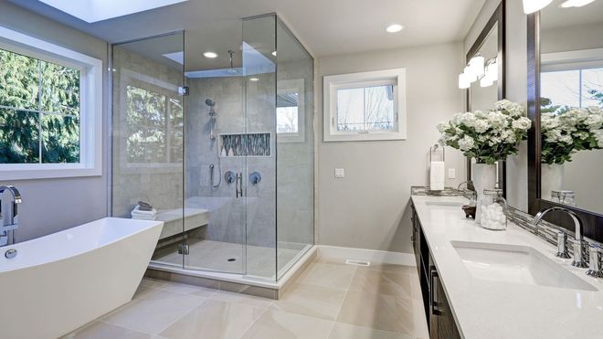 A bathroom with a tub , sink , and walk in shower.