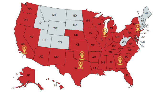 U.S. map with many states shaded red and several highlighted yellow location pins across the country