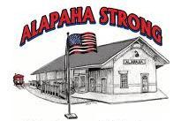 "Alapaha Strong" logo featuring the Alapaha train depot, waving American flag, and a train; red and black text."