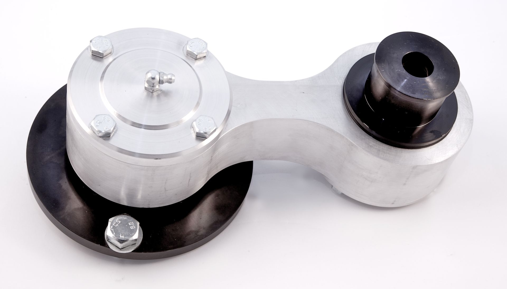 A mechanical serpentine belt tensioner with an aluminum arm, a black pulley, and a grease fitting on a white background.