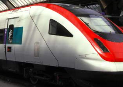White high-speed train with red stripe at a station platform