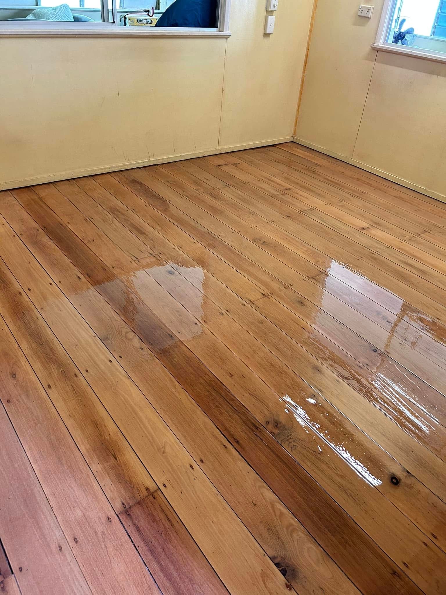 Wood Floor With Shiny Wet Varnish In A Room — Scott Johnston Floor Sanding in Bentley Park, QLD