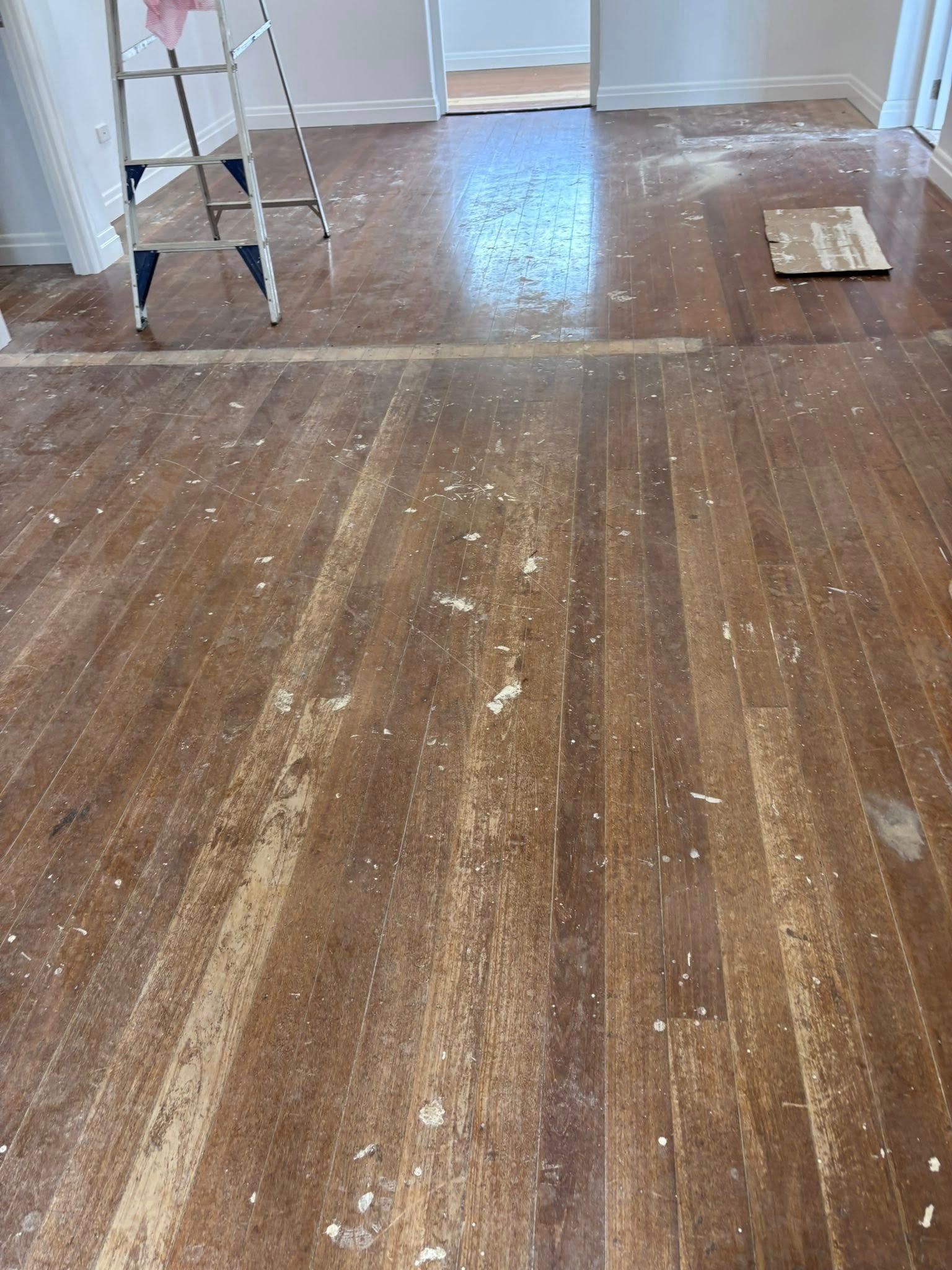 Hardwood Floor With Varying Wood Tones Arranged Horizontally — Scott Johnston Floor Sanding in Bentley Park QLD